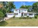 Inviting two-story home with lush landscaping and a brick driveway at 1405 Hilltop Dr, Mount Dora, FL 32757