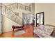 Open foyer with decorative iron staircase, sitting area, and terracotta tile flooring at 1405 Hilltop Dr, Mount Dora, FL 32757