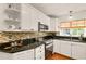 Galley kitchen features stainless appliances, tile backsplash, ample counter space and modern cabinetry at 1405 Hilltop Dr, Mount Dora, FL 32757