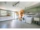 Spacious garage laundry area with sink, white cabinets and epoxy floors at 1405 Hilltop Dr, Mount Dora, FL 32757