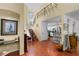 Open-concept living area with terracotta tile floors and decorative staircase at 1405 Hilltop Dr, Mount Dora, FL 32757