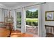 View from the dining room to the patio, which features a beautiful green backyard at 1405 Hilltop Dr, Mount Dora, FL 32757