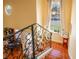 Inviting foyer staircase with decorative wrought iron railing, terracotta tile floors and an abundance of natural light at 1405 Hilltop Dr, Mount Dora, FL 32757