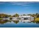 Waterfront image of a boathouse featuring multiple covered boat slips and boats docked on the water at 1405 Hilltop Dr, Mount Dora, FL 32757