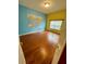 Bedroom featuring colorful walls, a world map decal, hardwood floors, and window with blind at 3721 Plantation Blvd, Leesburg, FL 34748