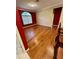 Spacious living room with hardwood floors, decorative moulding, and red accent wall at 3721 Plantation Blvd, Leesburg, FL 34748