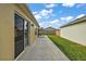 Landscaped backyard with grassy area and concrete patio at 5738 Leigh Ln, The Villages, FL 32163