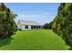 Large, beautifully maintained backyard surrounded by lush greenery and mature trees at 956 Chula Ct, The Villages, FL 32159