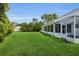Expansive backyard showcases lush green grass and mature trees, perfect for outdoor enjoyment at 956 Chula Ct, The Villages, FL 32159