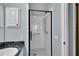 Bright bathroom with a glass-enclosed shower and dark granite countertop at 956 Chula Ct, The Villages, FL 32159