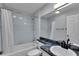 Bathroom with blue tiling, granite countertop, sink and shower at 956 Chula Ct, The Villages, FL 32159