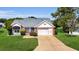 Charming single-story home with a well-manicured lawn and inviting curb appeal at 956 Chula Ct, The Villages, FL 32159