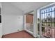 A screened-in front porch with a view of the landscaped front yard and neighborhood at 956 Chula Ct, The Villages, FL 32159