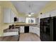 Bright kitchen featuring white cabinetry, modern appliances, and a ceiling fan at 956 Chula Ct, The Villages, FL 32159