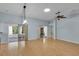 Bright living room with wood floors, light blue walls, recessed lights, and sliding glass doors at 956 Chula Ct, The Villages, FL 32159