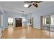 Spacious living room with light blue walls, wood floors, and sliding glass doors to the porch at 956 Chula Ct, The Villages, FL 32159