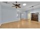 Large living room with light blue walls, wood floors, ceiling fan, and visible entryways at 956 Chula Ct, The Villages, FL 32159
