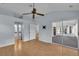Main bedroom with light wood floors, ensuite bath and sitting room with sliding glass doors at 956 Chula Ct, The Villages, FL 32159