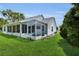 Enclosed and screened porch offers a perfect space for relaxation and outdoor living at 956 Chula Ct, The Villages, FL 32159