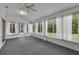 Sunroom with ceiling fan and multiple windows providing natural light and outdoor views at 956 Chula Ct, The Villages, FL 32159