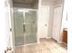 Bathroom featuring a glass shower enclosure, neutral tile flooring, and a wooden vanity at 2059 Newtown Rd, Groveland, FL 34736