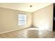 Bedroom with neutral walls, tile floors, and natural light from the window at 2059 Newtown Rd, Groveland, FL 34736