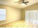 Bedroom with neutral walls, ceiling fan, tile floors, and large windows for natural light at 2059 Newtown Rd, Groveland, FL 34736