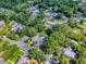 Drone shot of a residential community with large trees surrounding a property and pool at 351 W 10Th Ave, Mount Dora, FL 32757