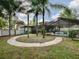 The well-maintained backyard features a circular sidewalk, tropical trees, pool and screened-in area at 351 W 10Th Ave, Mount Dora, FL 32757