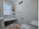 Cozy bathroom with a clawfoot tub, white hexagon tile, and built-in storage shelves at 351 W 10Th Ave, Mount Dora, FL 32757