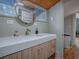 Bright bathroom features a white marble vanity, and a window above the toilet, with wood ceiling at 351 W 10Th Ave, Mount Dora, FL 32757