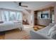 Bright bedroom features hardwood floors, neutral walls, a ceiling fan, and large windows with lots of light at 351 W 10Th Ave, Mount Dora, FL 32757