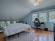 A bright bedroom featuring hardwood floors, neutral walls, and large windows that let in natural light at 351 W 10Th Ave, Mount Dora, FL 32757