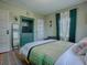 Comfortable bedroom with a green accent wall, a built-in cabinet, and a yellow upholstered bed at 351 W 10Th Ave, Mount Dora, FL 32757