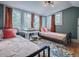 This cozy bedroom features two twin beds, two windows, and warm-toned decor at 351 W 10Th Ave, Mount Dora, FL 32757
