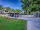 Exterior view of a large covered carport with lush green lawn and mature landscaping at 351 W 10Th Ave, Mount Dora, FL 32757