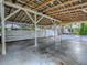 Large carport view showing the beam structure with concrete floor and white support beams at 351 W 10Th Ave, Mount Dora, FL 32757