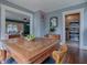 Dining room with hardwood floors, classic table, and view into a kitchen and living room at 351 W 10Th Ave, Mount Dora, FL 32757