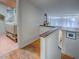 Bright hallway with hardwood floors, open to an upstairs bathroom with pink tile floors and a custom sink at 351 W 10Th Ave, Mount Dora, FL 32757