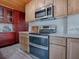 Modern kitchen featuring stainless steel appliances, custom cabinets, and marble countertops at 351 W 10Th Ave, Mount Dora, FL 32757