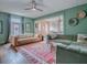 Inviting living room featuring hardwood floors, stylish sofas, ceiling fan and a decorative area rug at 351 W 10Th Ave, Mount Dora, FL 32757