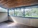 The enclosed porch has a wood ceiling, wood floor, and view of the landscaped yard at 351 W 10Th Ave, Mount Dora, FL 32757