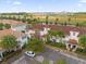 Aerial view of a real estate complex boasting well-maintained landscaping and ample parking at 4847 Clock Tower Dr, Kissimmee, FL 34746