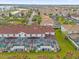 Aerial view of a residential neighborhood with screened-in pools and tile roofs at 4847 Clock Tower Dr, Kissimmee, FL 34746