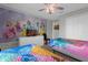 The spacious ' bedroom is decorated with a princess theme mural, and two twin beds at 4847 Clock Tower Dr, Kissimmee, FL 34746