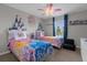 Bedroom with themed decor, two twin beds, ceiling fan, and window at 4847 Clock Tower Dr, Kissimmee, FL 34746