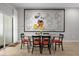 Dining room with a glass table and chairs, as well as a large Mickey Mouse wall picture at 4847 Clock Tower Dr, Kissimmee, FL 34746
