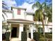 Charming two-story townhome with a tile roof, brown shutters, and meticulously maintained landscaping at 4847 Clock Tower Dr, Kissimmee, FL 34746