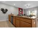 Eat-in kitchen featuring granite countertops, wood cabinets, stainless steel appliances, and a view to the living area at 4847 Clock Tower Dr, Kissimmee, FL 34746