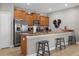 Eat-in kitchen with stainless steel appliances, granite counters, and cozy breakfast bar at 4847 Clock Tower Dr, Kissimmee, FL 34746